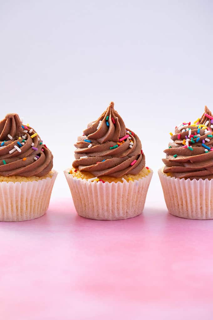 Beautiful cupcakes topped with big swirls of chocolate frosting 