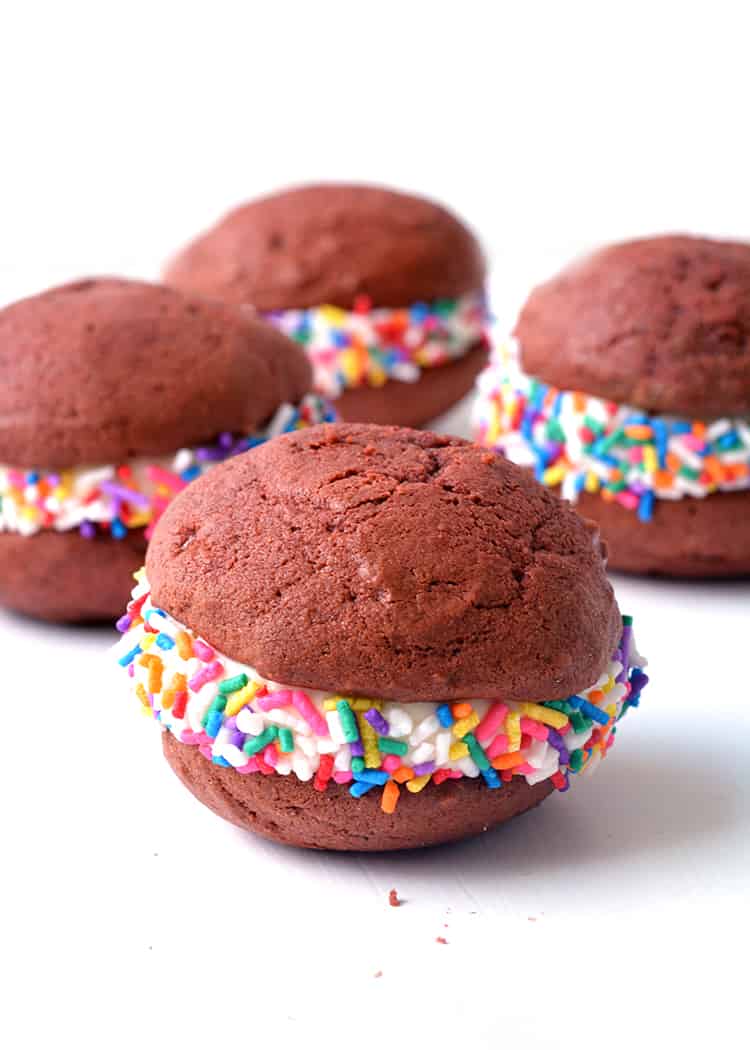 Red velvet whoopie pies with cream cheese frosting and sprinkles