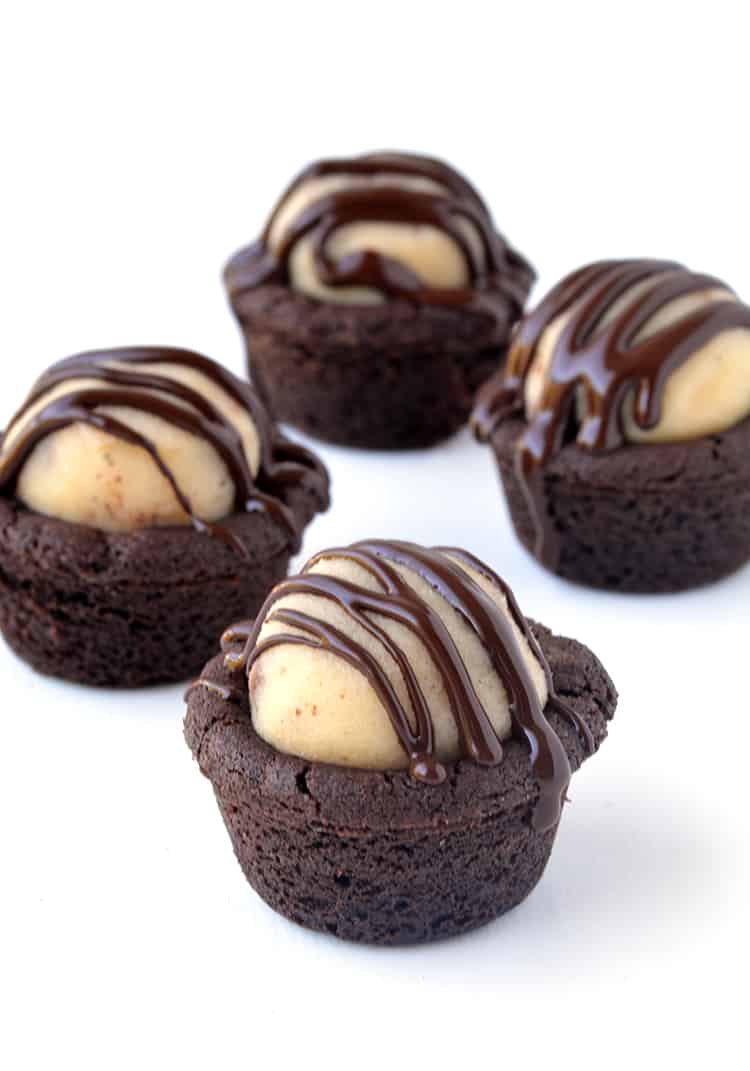 Chocolate cookie cups filled with cookie dough and drizzled with chocolate