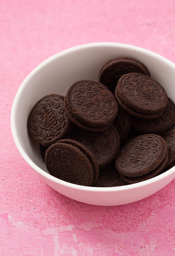 A bowl of Oreo Cookies on a pink background