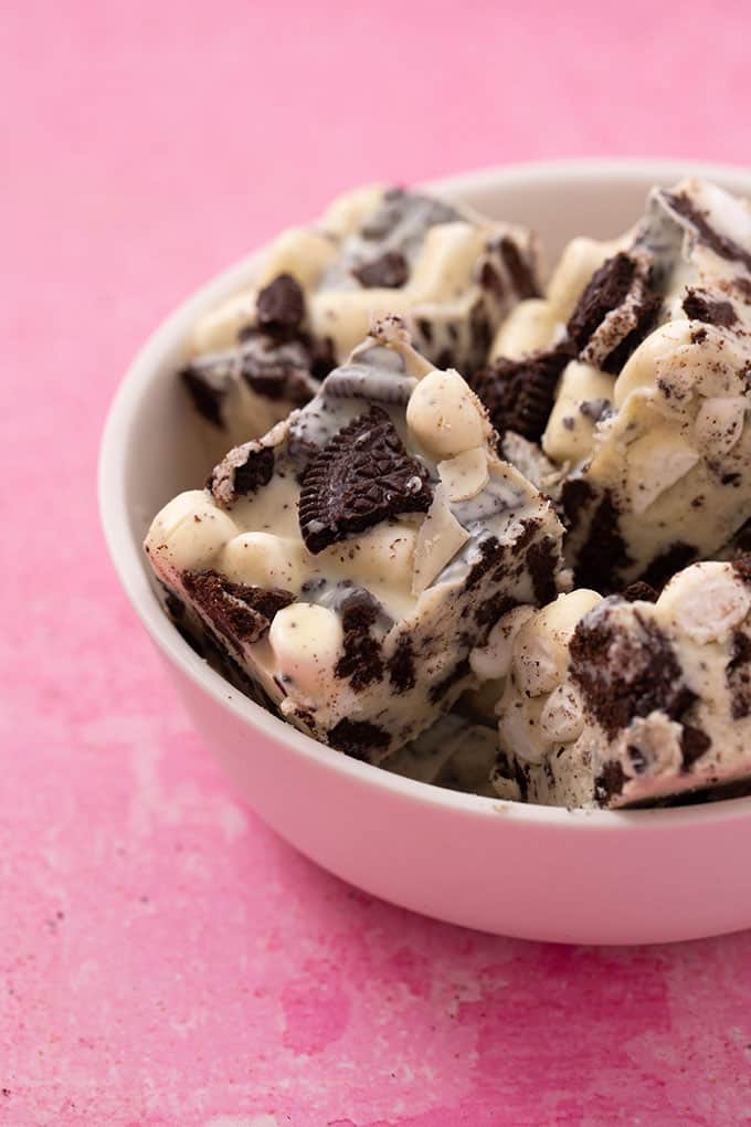 A bowl of homemade Cookies and Cream Rocky Road on a pink background.