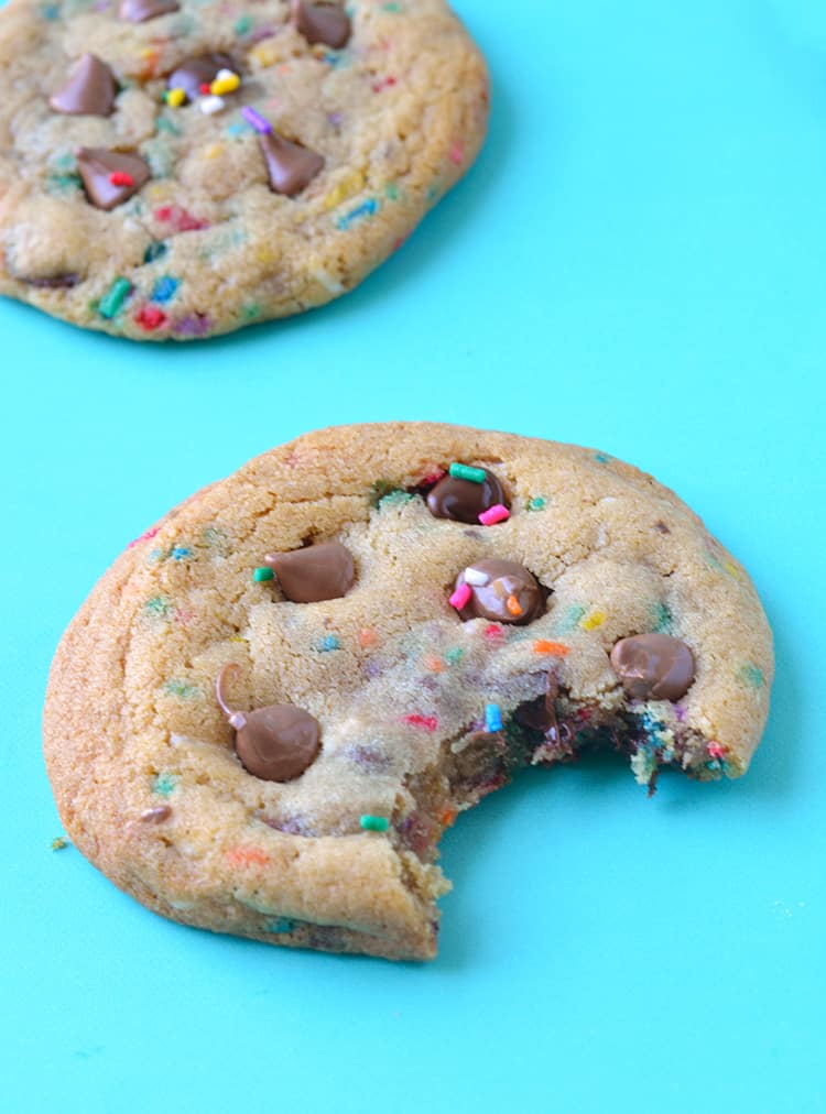 A Funfetti Chocolate Chip Cookie with a bite taken out of it