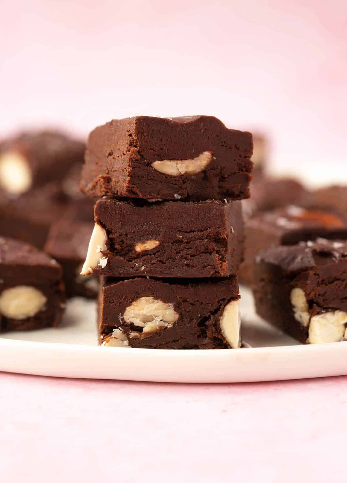 A stack of Chocolate Almond Fudge on a white plate.
