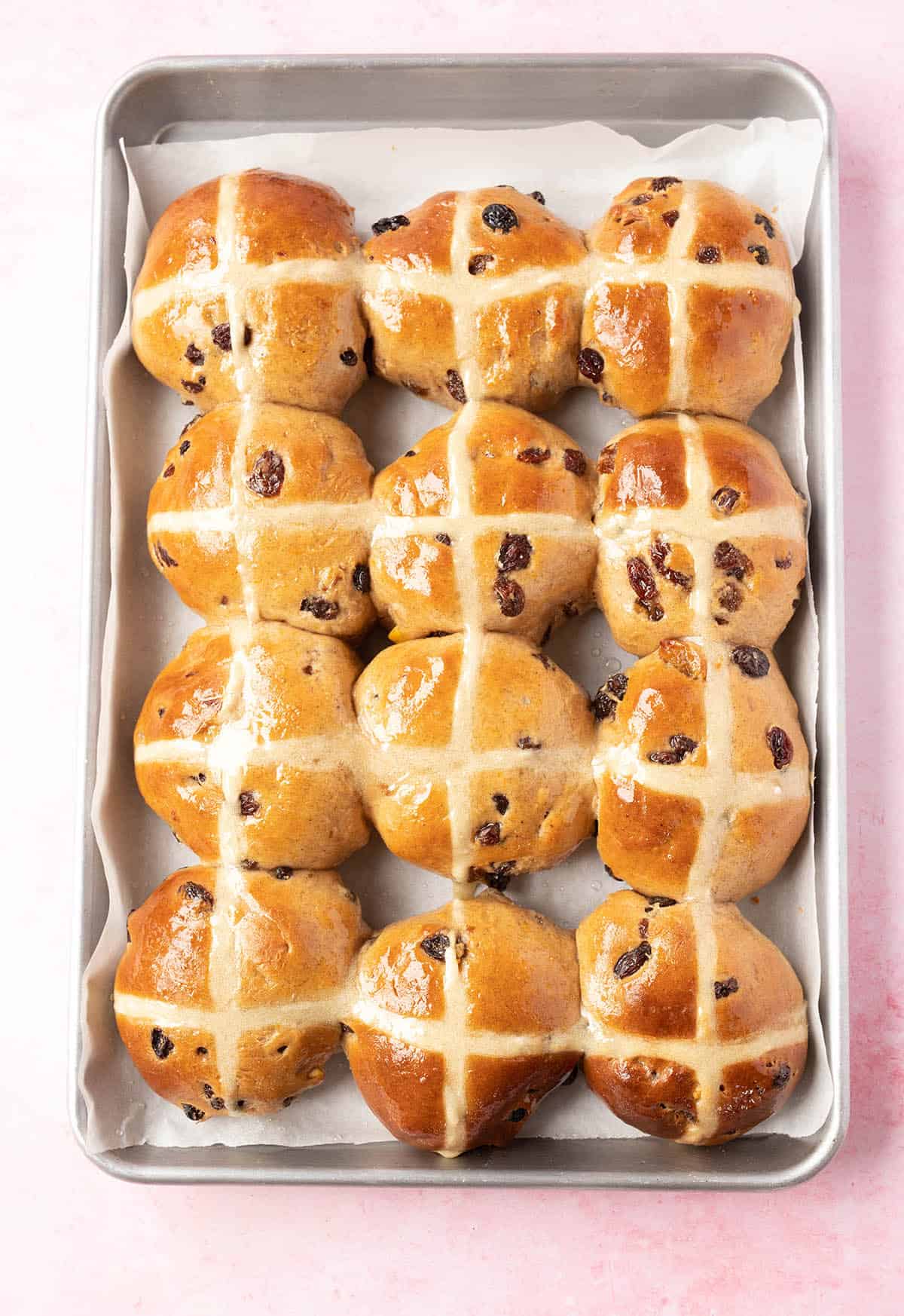 Top view of 12 hot cross buns fresh from the oven.