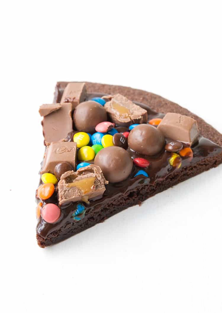 A slice of M&M Chocolate Brownie Pizza 