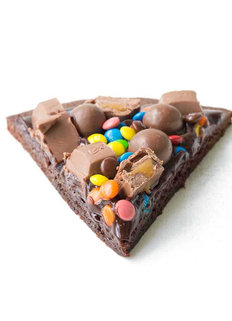 A slice of M&M Chocolate Brownie Pizza