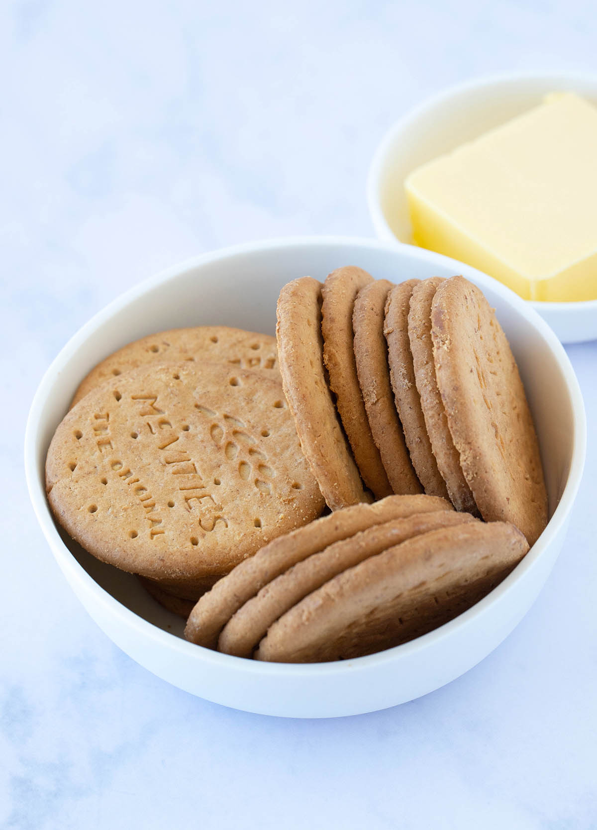 A white bowl filled with digestive cookies