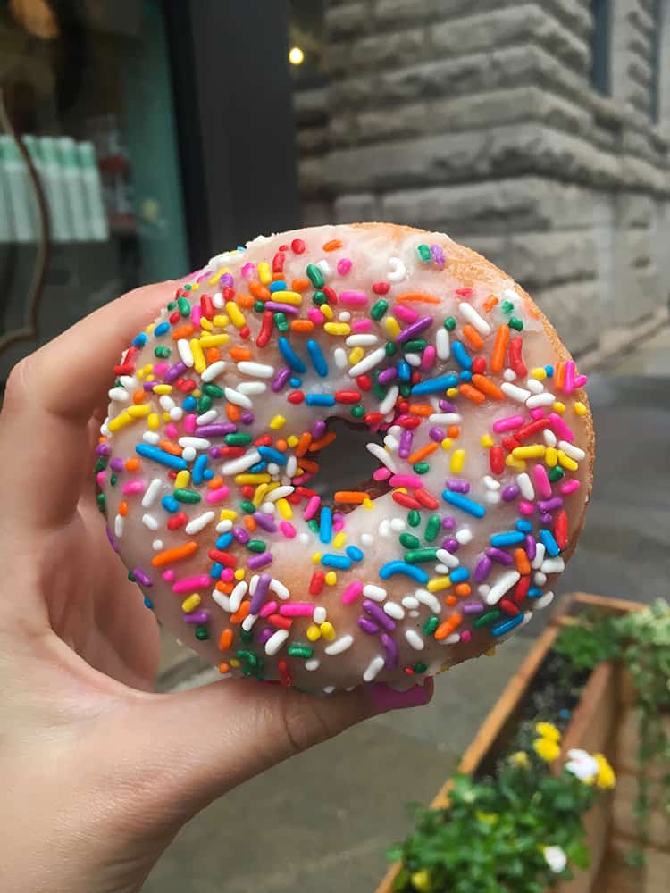 Donut covered in colourful sprinkles