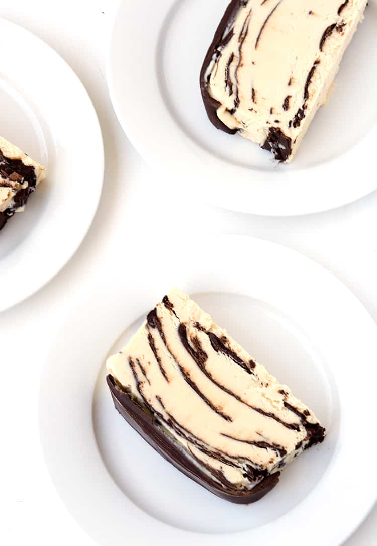 Slices of peanut butter ice cream cake on white plates