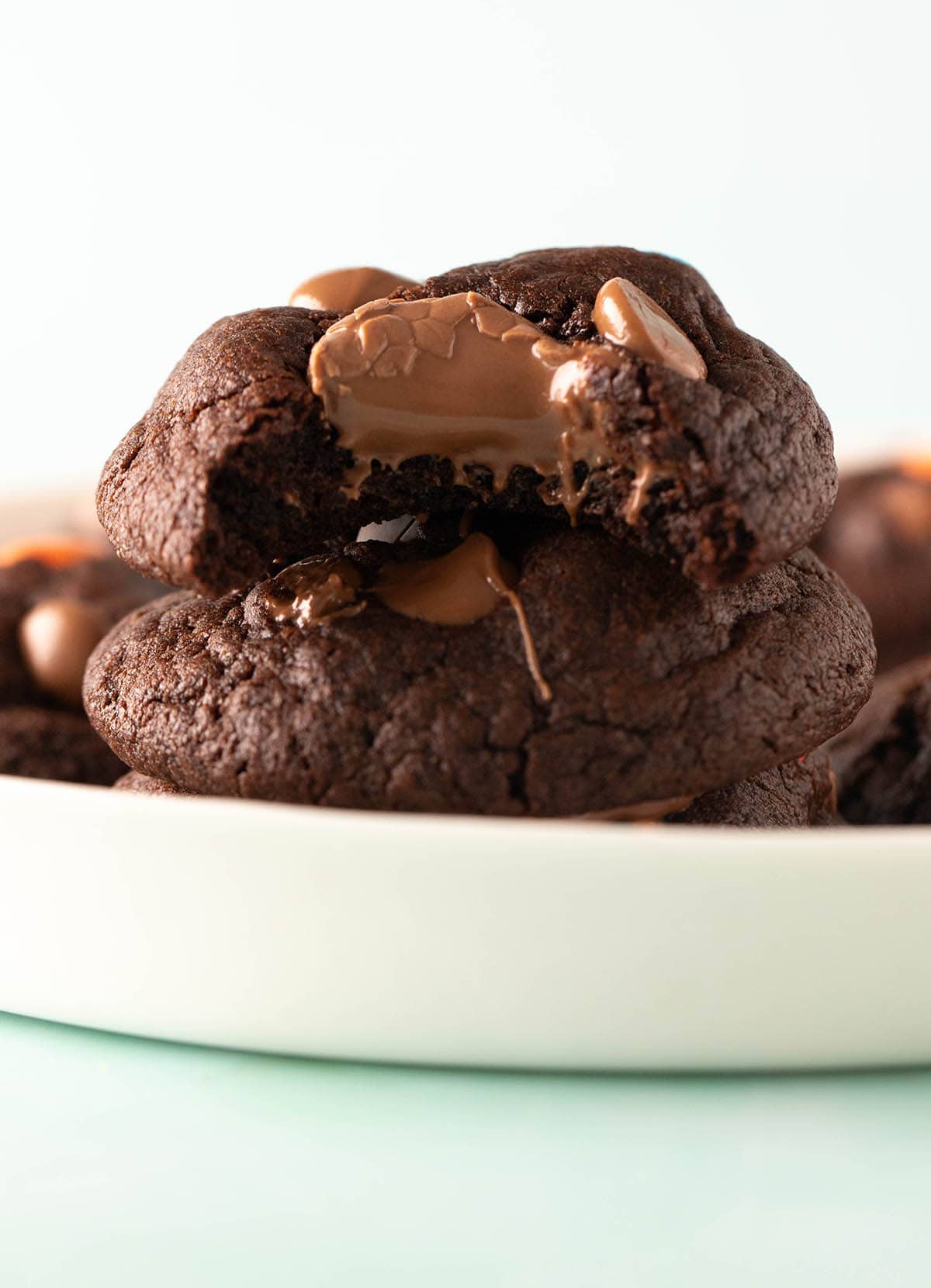 A tall stack of chocolate Easter egg cookies with a bite taken out of it.