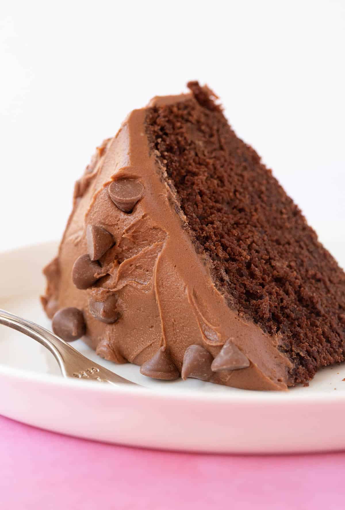 A slice of Chocolate Buttermilk Cake on a white plate. 
