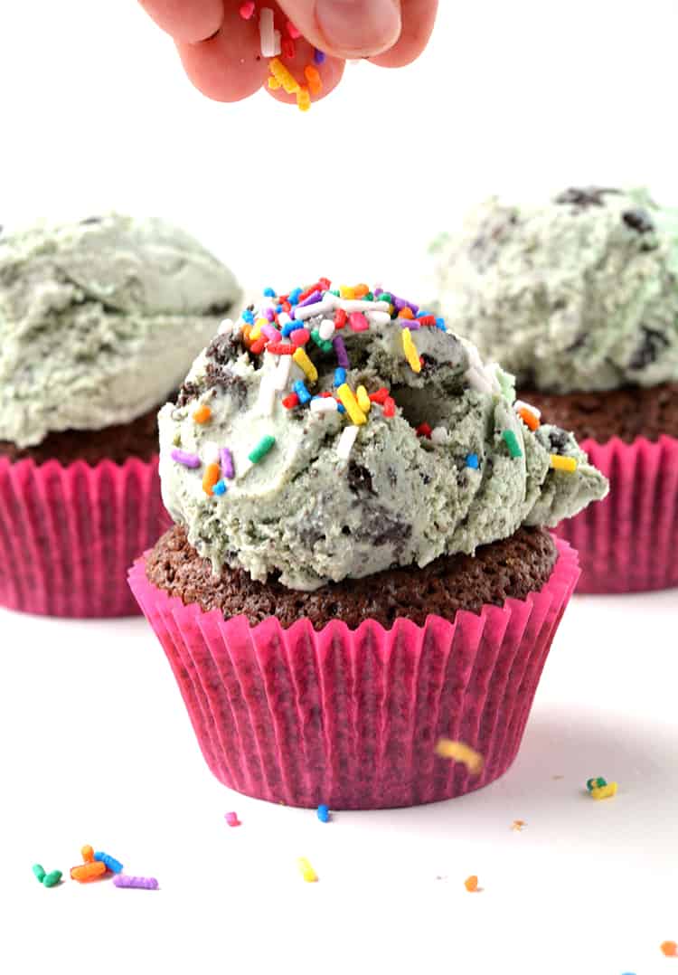 Brownie cupcakes with hand scattering sprinkles on top