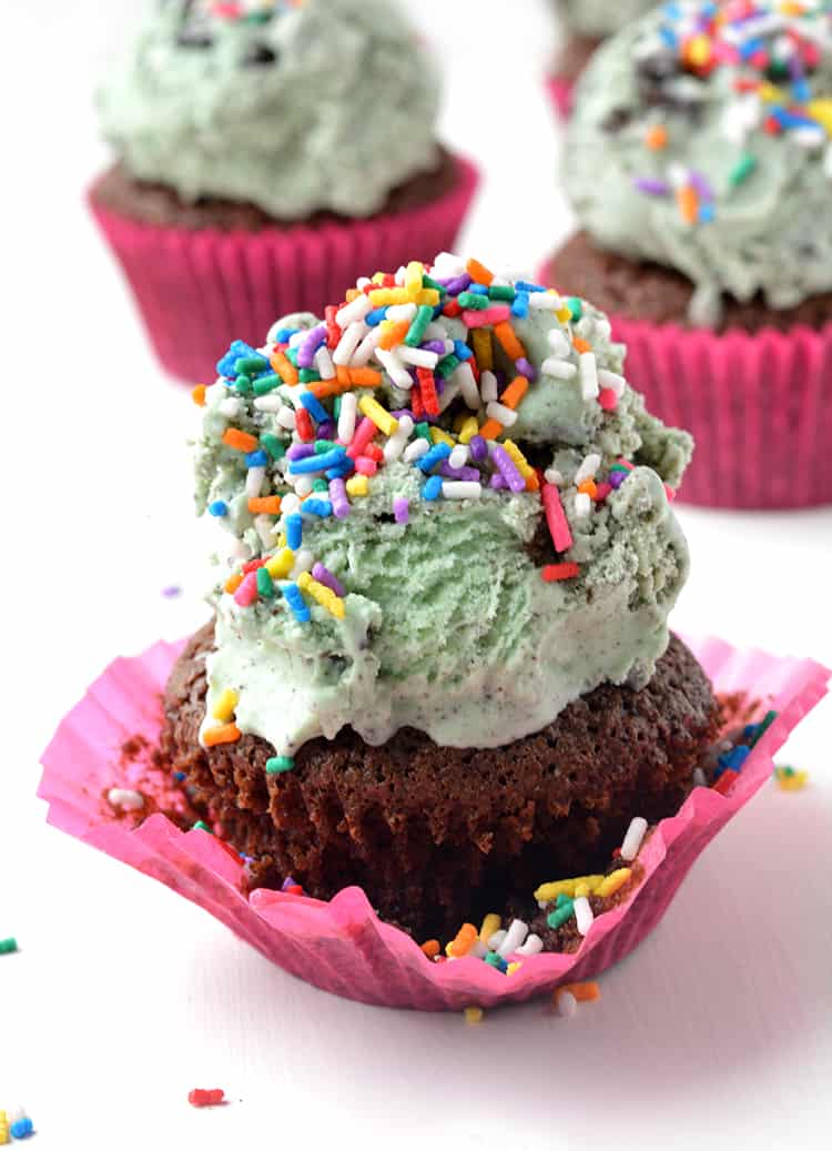 Brownie cupcakes topped with ice cream and sprinkles