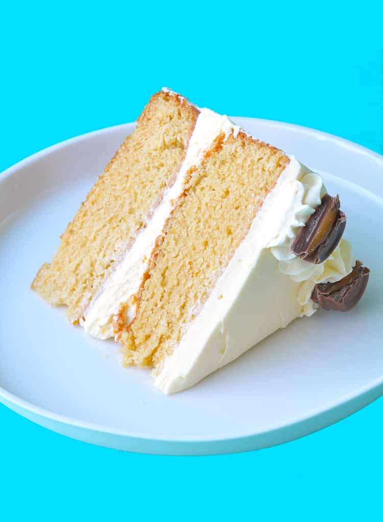 A slice of two layer Caramel Mud Cake on a white plate
