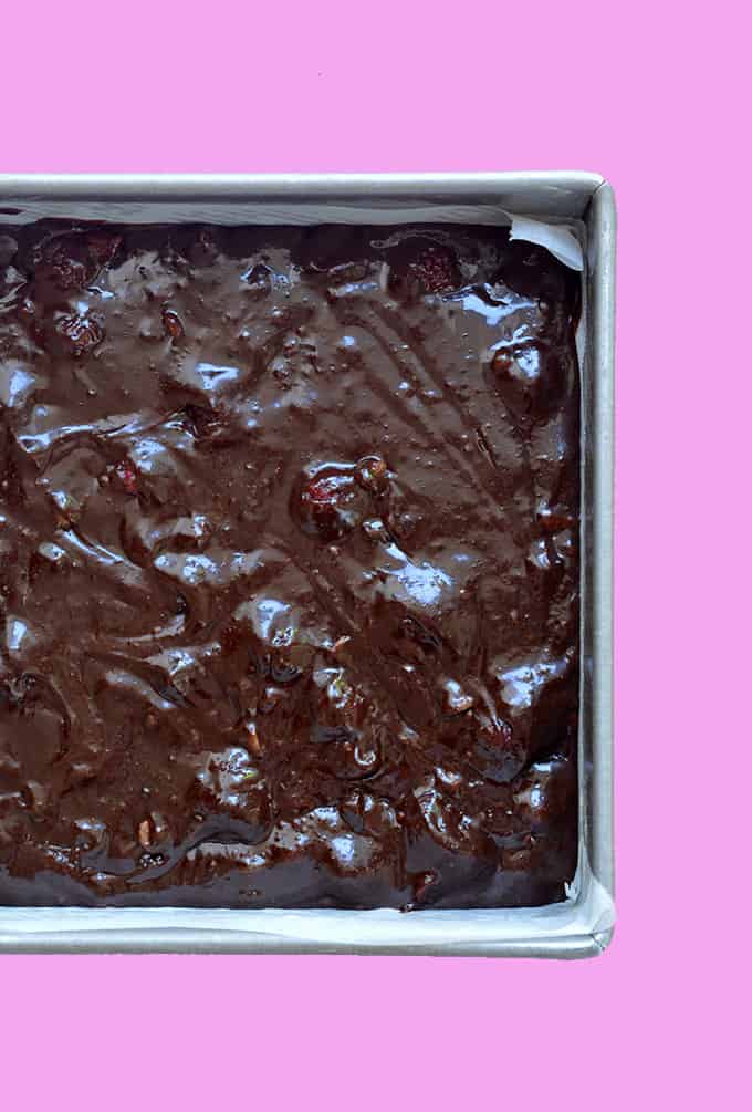 Chocolate brownie batter in a cake tin