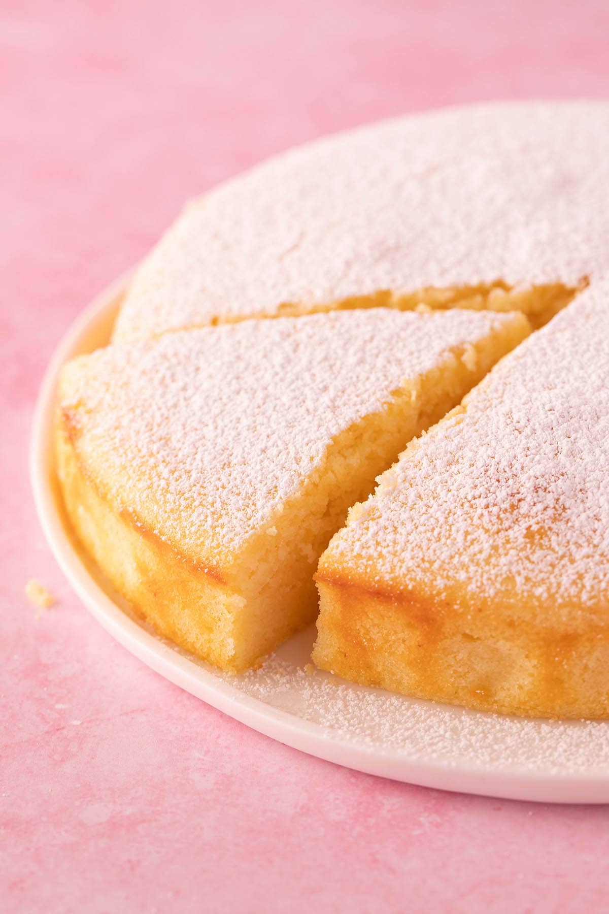 Freshly made Lemon Ricotta Cake dusted with icing sugar.