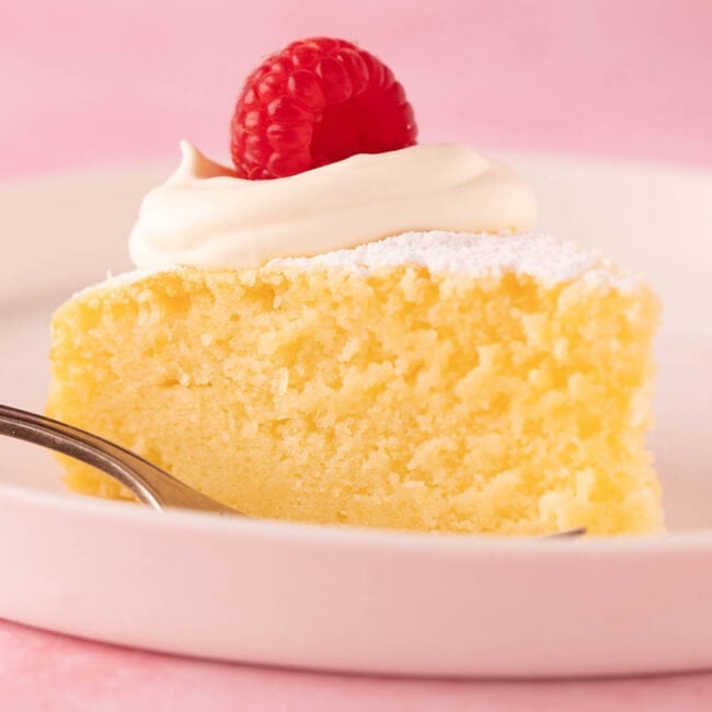 A big slice of homemade Lemon Ricotta Cake on a white plate