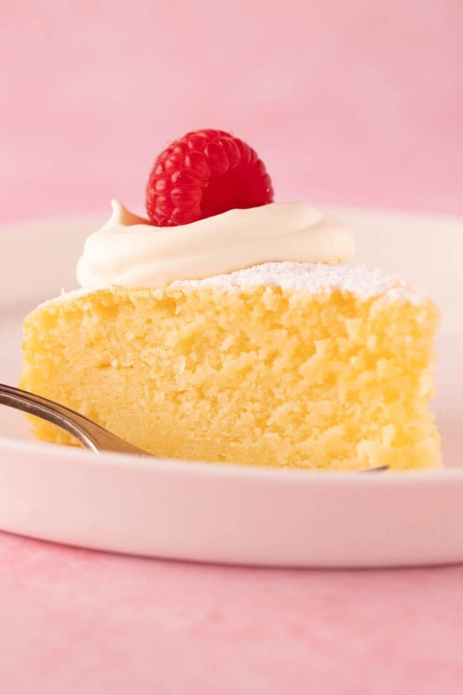 A big slice of homemade Lemon Ricotta Cake on a white plate