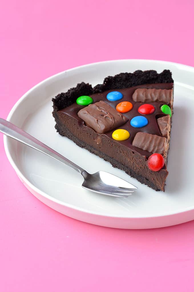 A slice of Candy Bar Chocolate Tart on a white plate