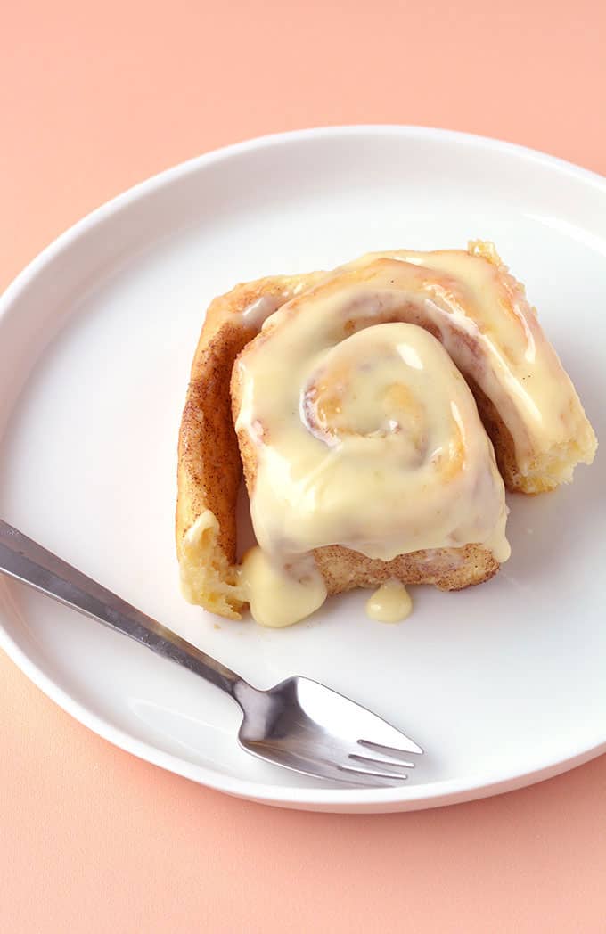 Top view of a Cinnamon Roll covered in cream cheese frosting
