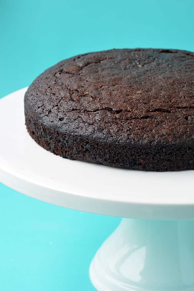 An Eggless Chocolate Cake on top of a cake stand