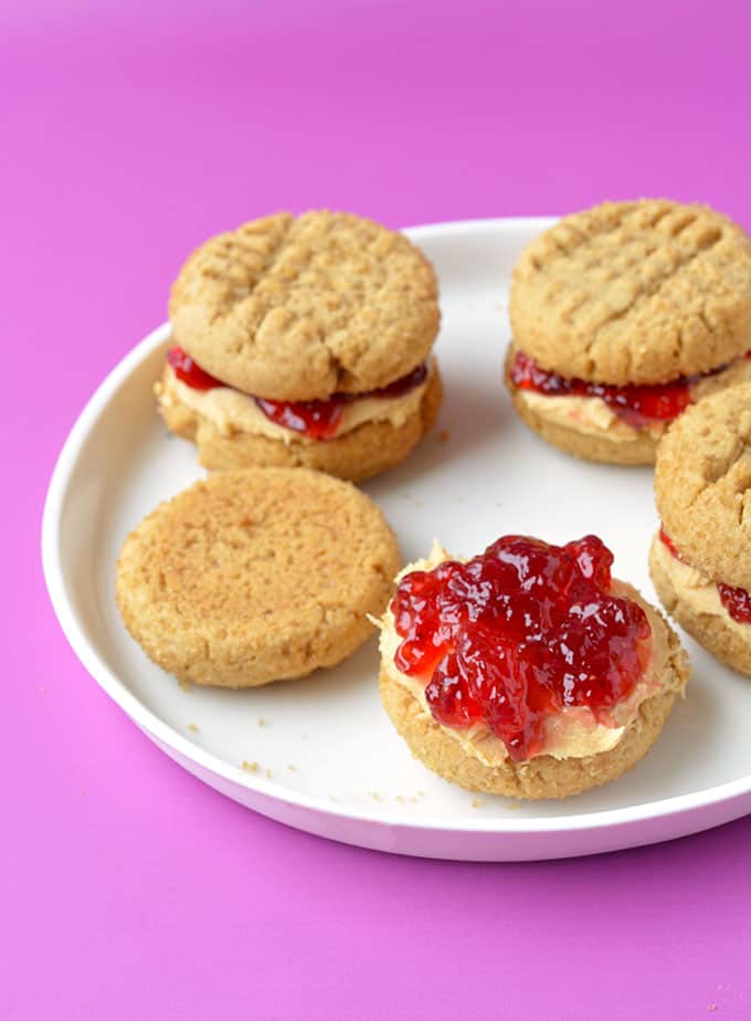 A peanut butter cookie topped with peanut butter frosting and strawberry jam