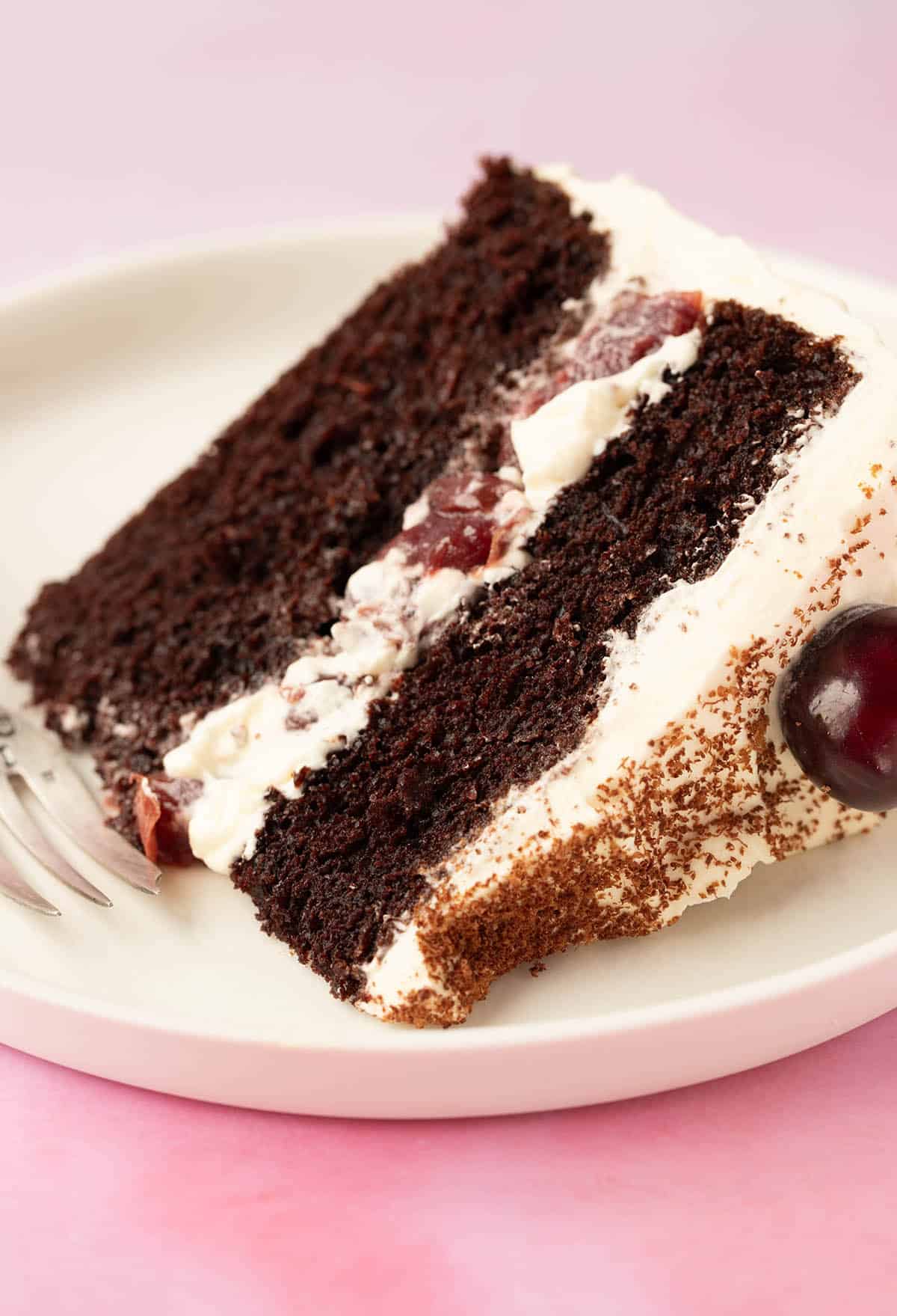 A slice of Black Forest Cake on a white plate. 