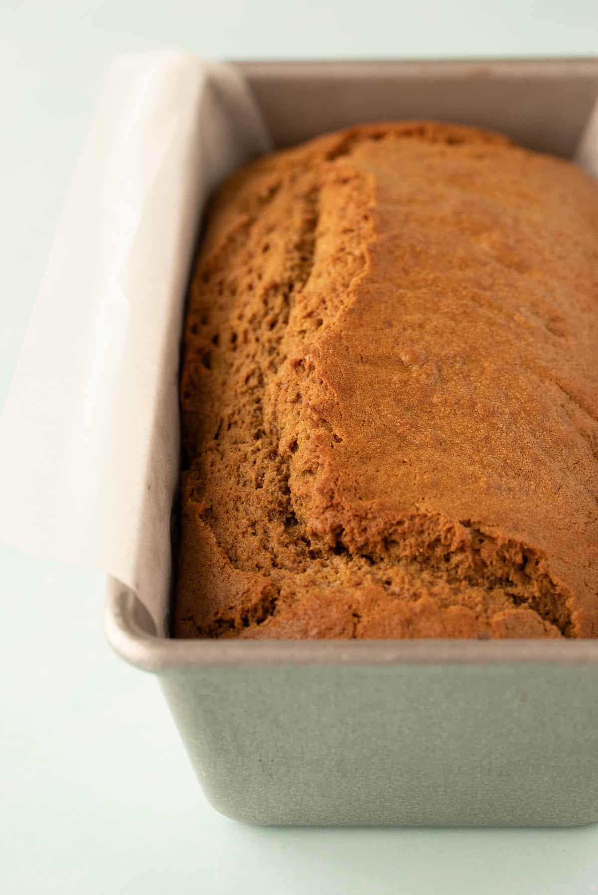 A Gingerbread Loaf Cake still in the cake pan fresh from the oven.