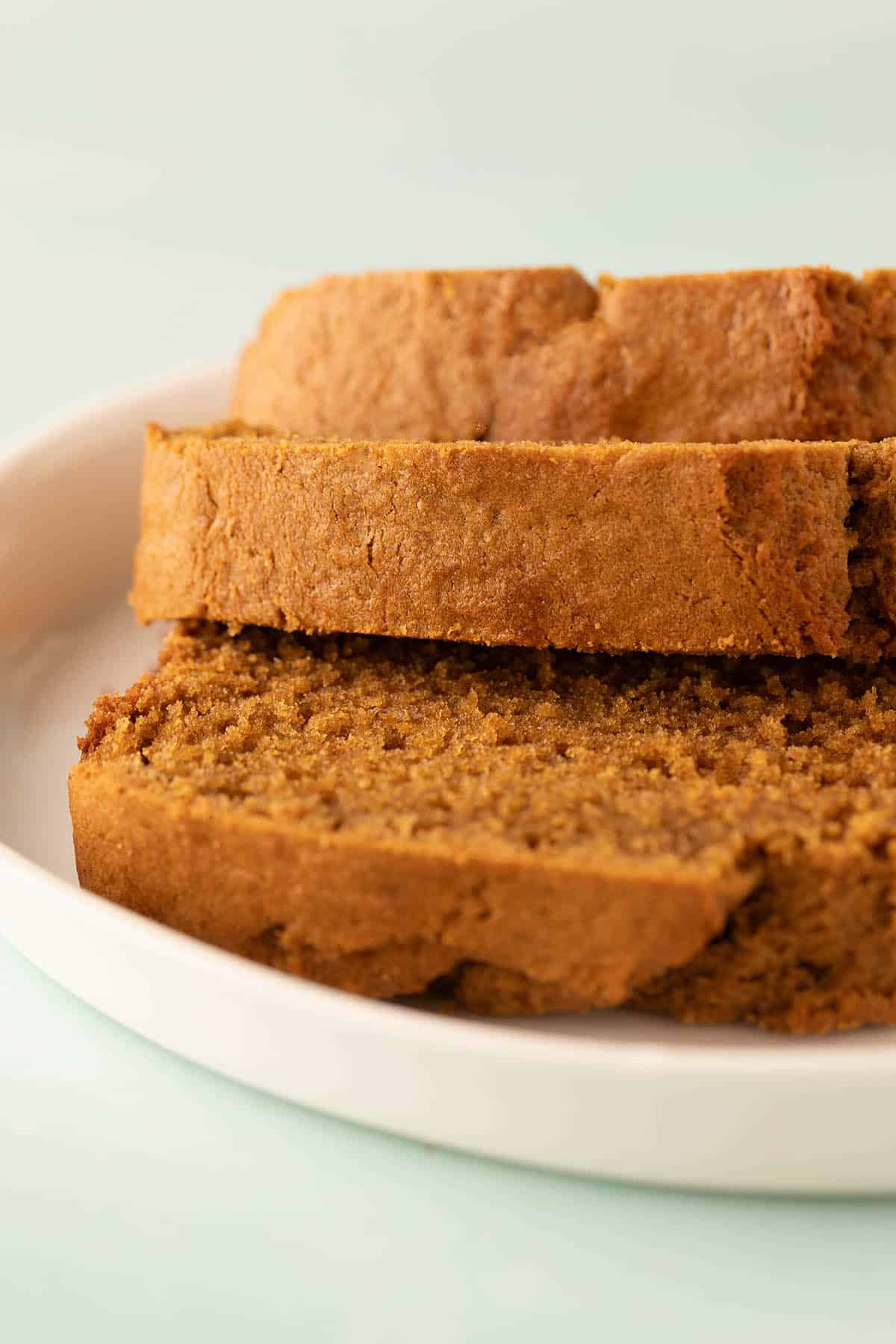 Crisp crust of gingerbread cake on a white plate. 