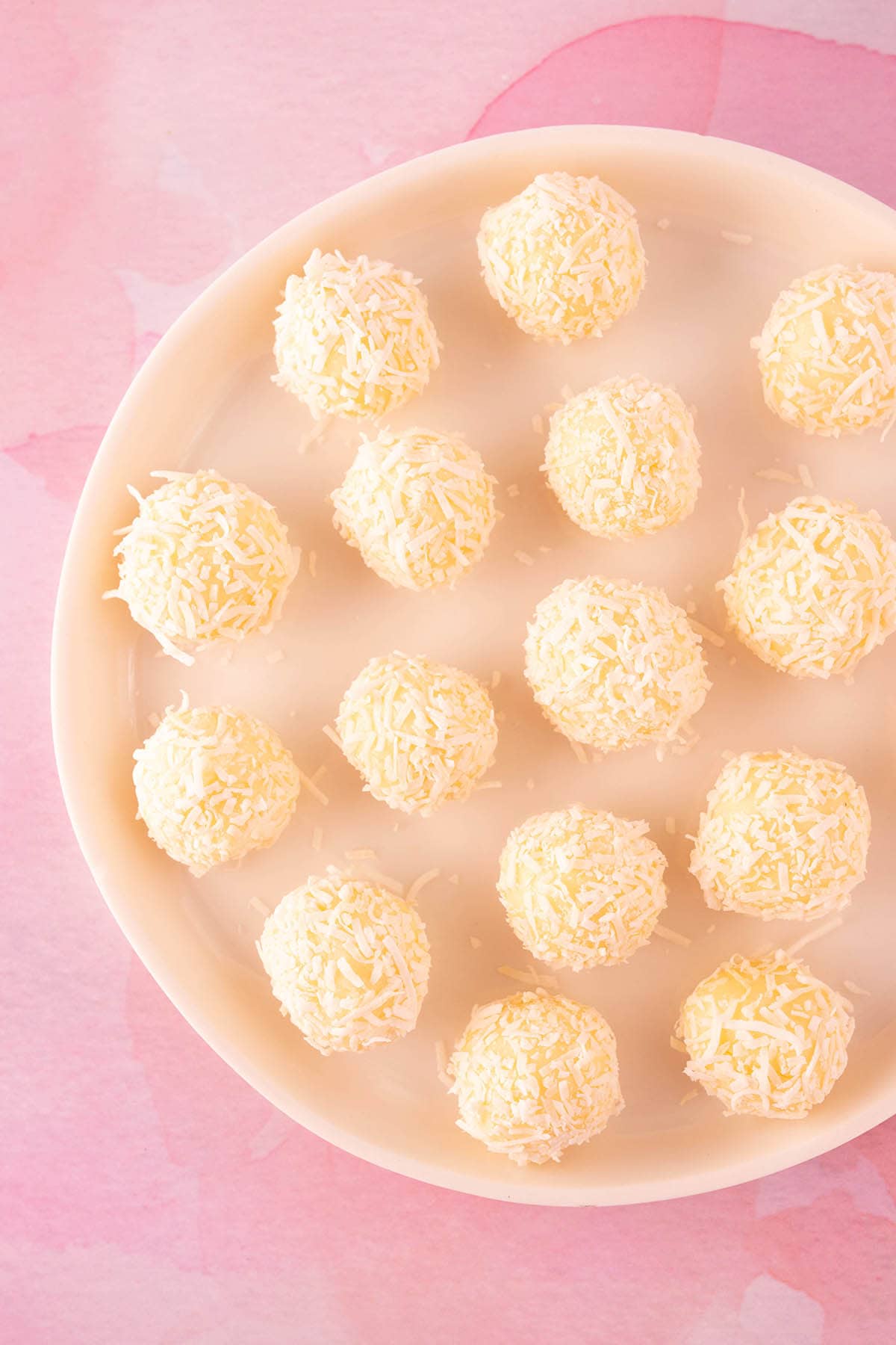 White Chocolate Ganache Truffles on a pink backdrop. 