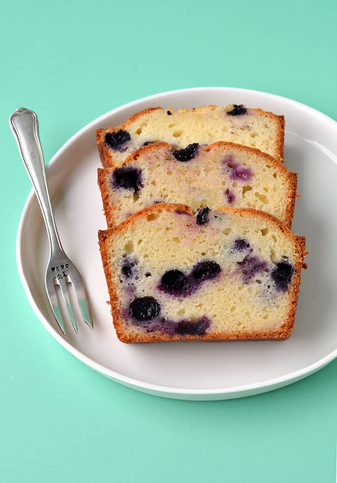 Three slices of Blueberry Bread on a white plate