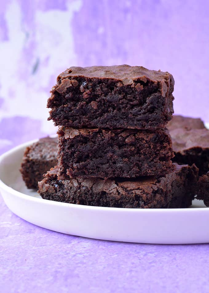A stack of Olive Oil Brownies on a white plate