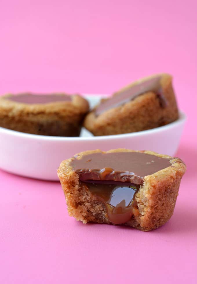 A homemade Twix Cookie Cup with caramel oozing out the middle