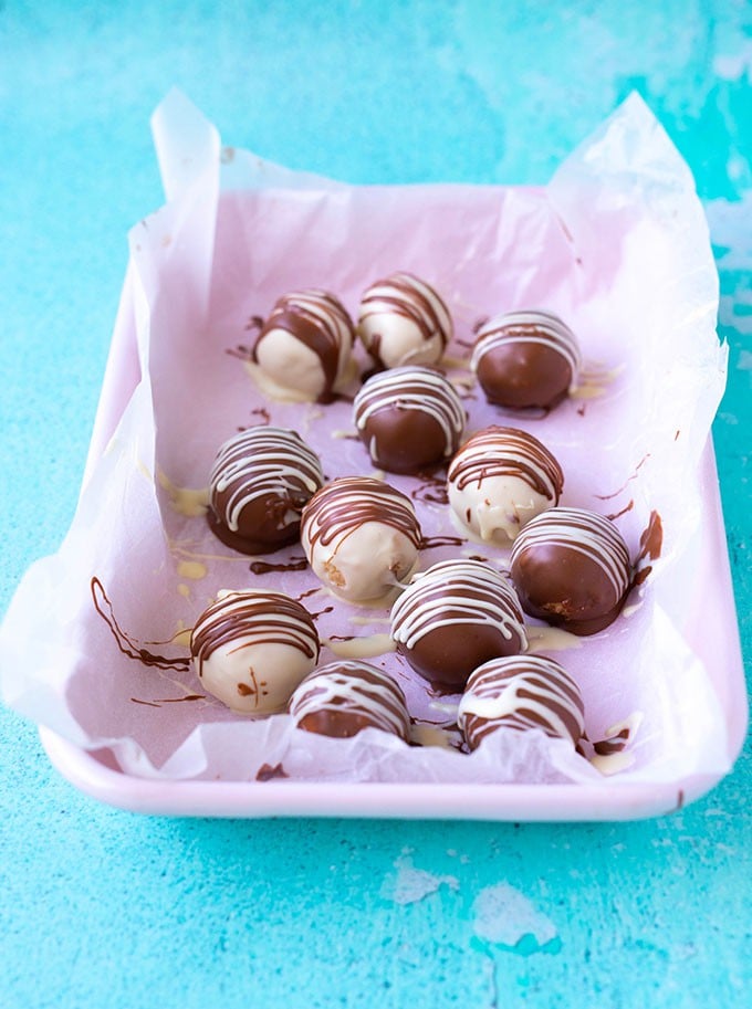 A pink tray filled with homemade Peanut Butter Truffles 
