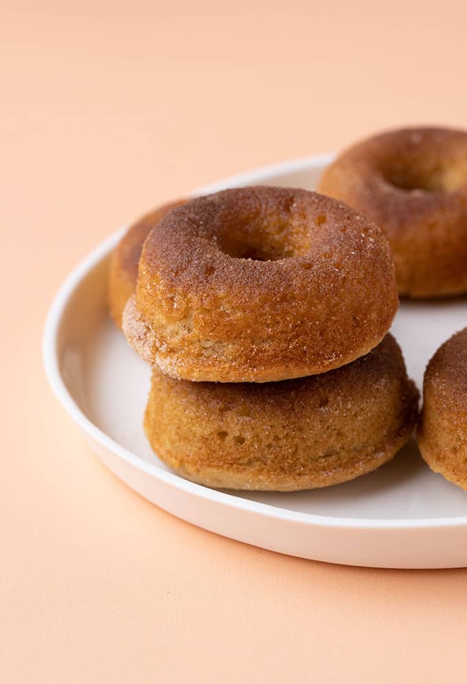 Homemade cinnamon donuts on a white plate