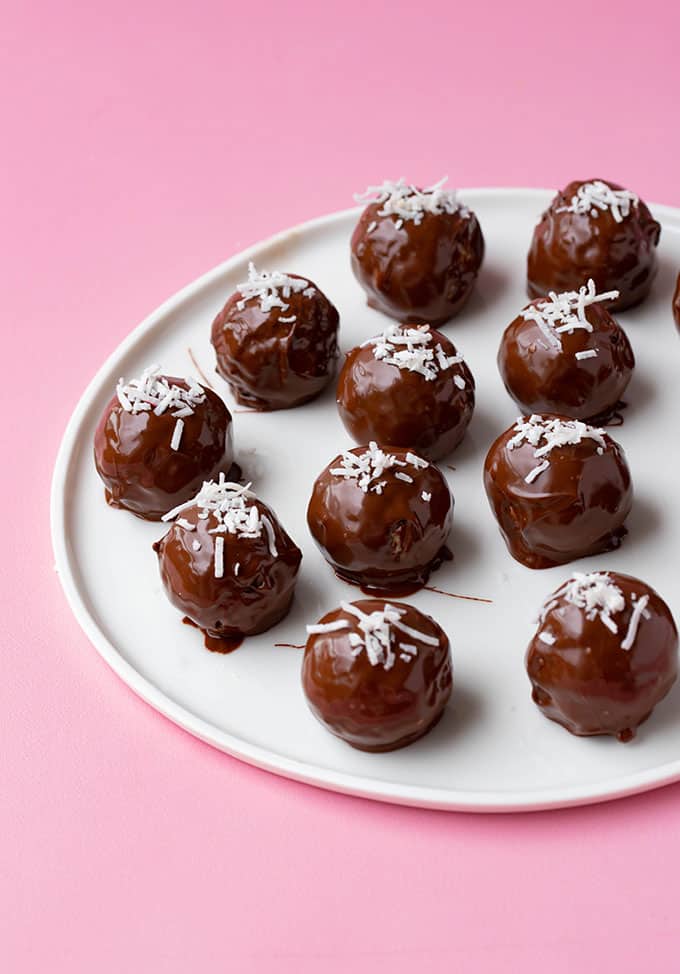 A white plate with chocolate coconut truffles