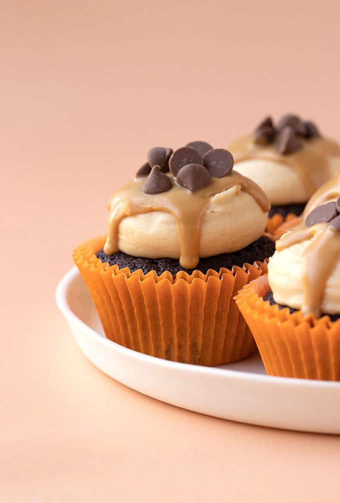 A close up of a Peanut Butter Chocolate Cupcakes drizzled with peanut butter