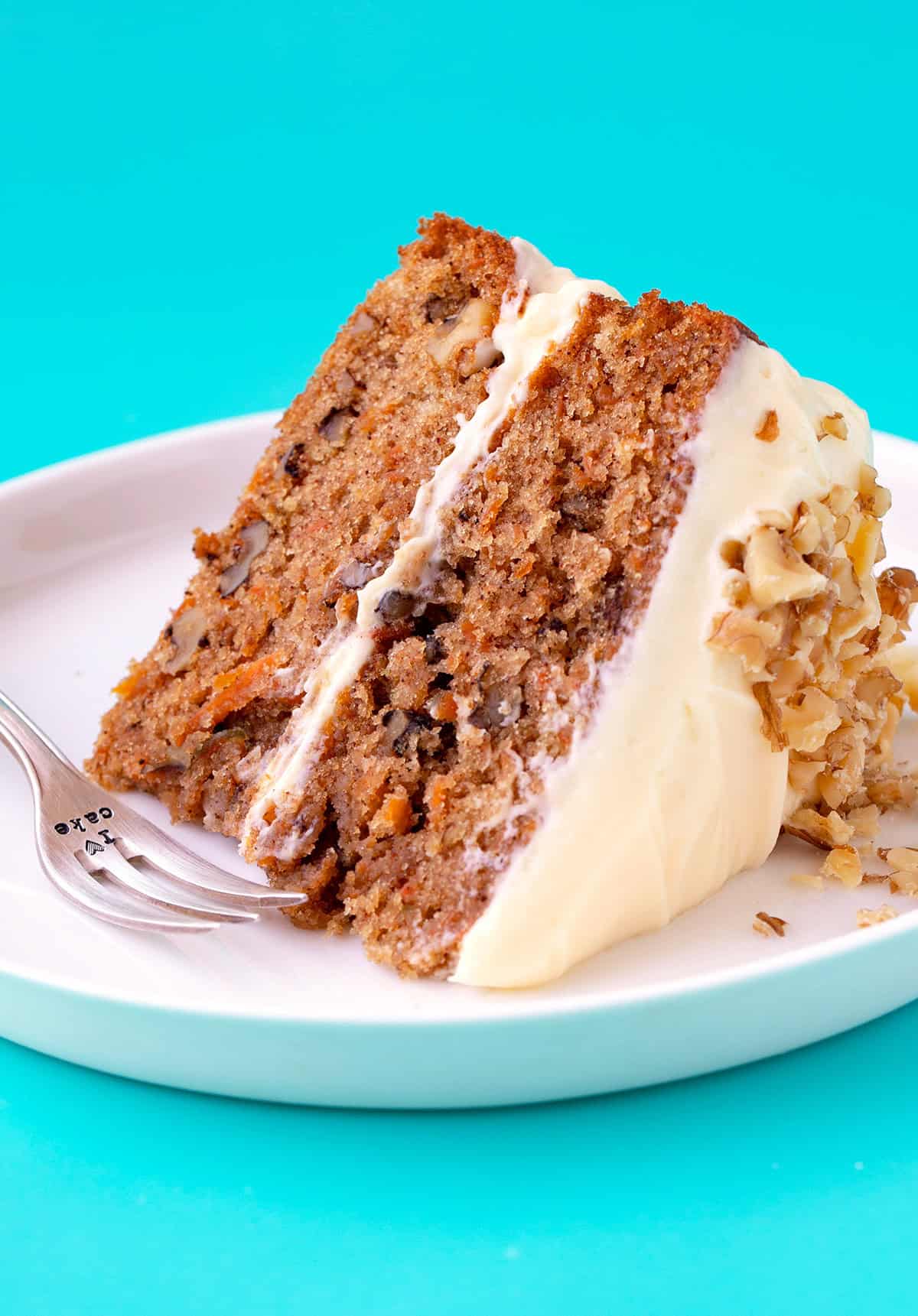 A big slice of Carrot Cake on a blue background