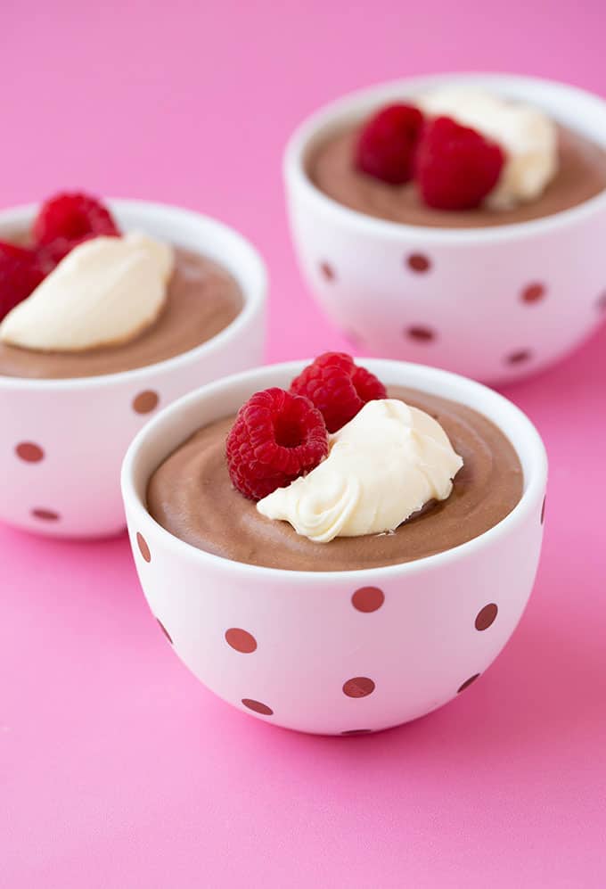 Homemade pots of Nutella Mousse topped with cream and berries