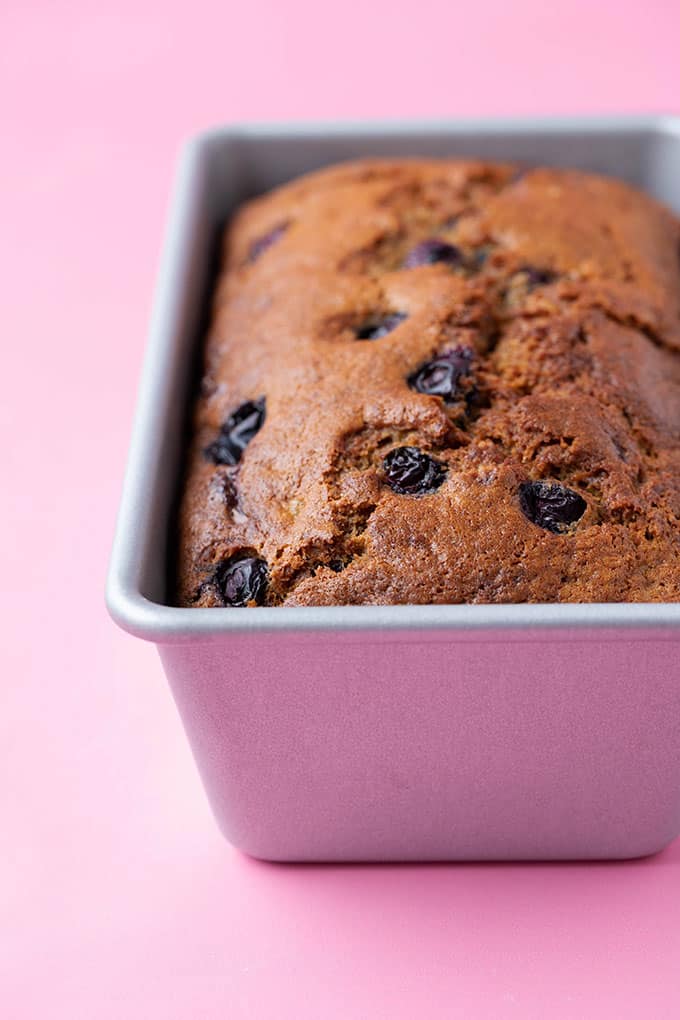 A loaf of blueberry banana bread in cake tin