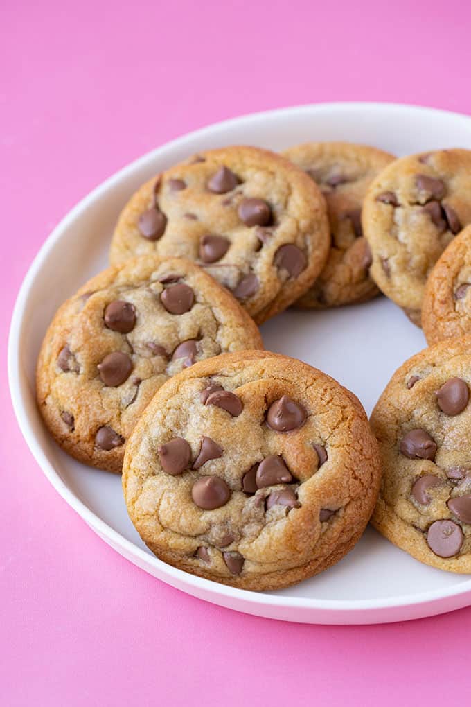 A plate of cookies on a pink background