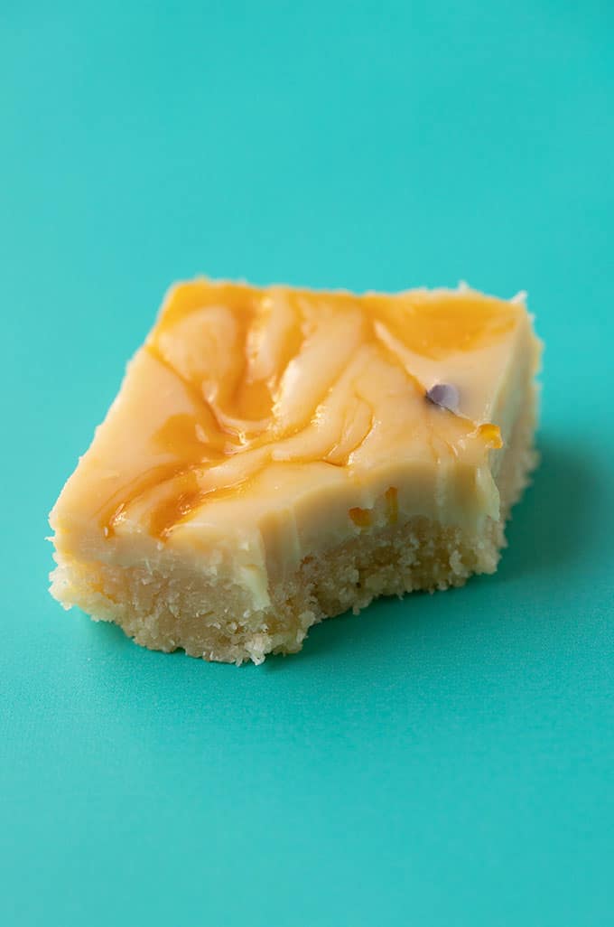 A piece of Passionfruit Slice with a bite taken out of it