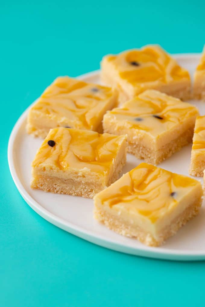 A plate of Passionfruit Slice on a turquoise background