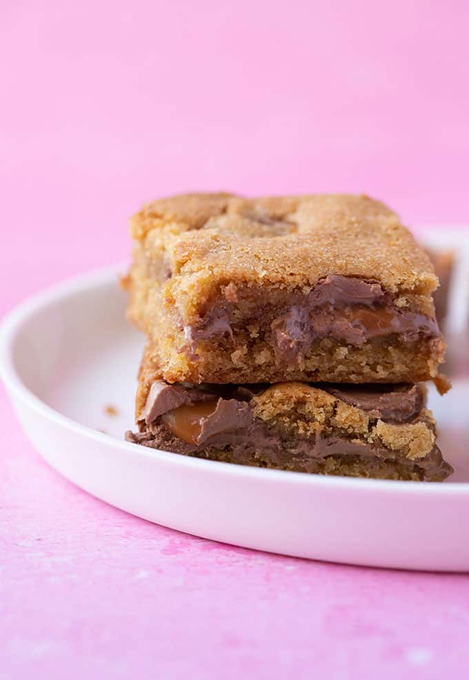 A plate with a stack of Rolo Stuffed Cookie Bars
