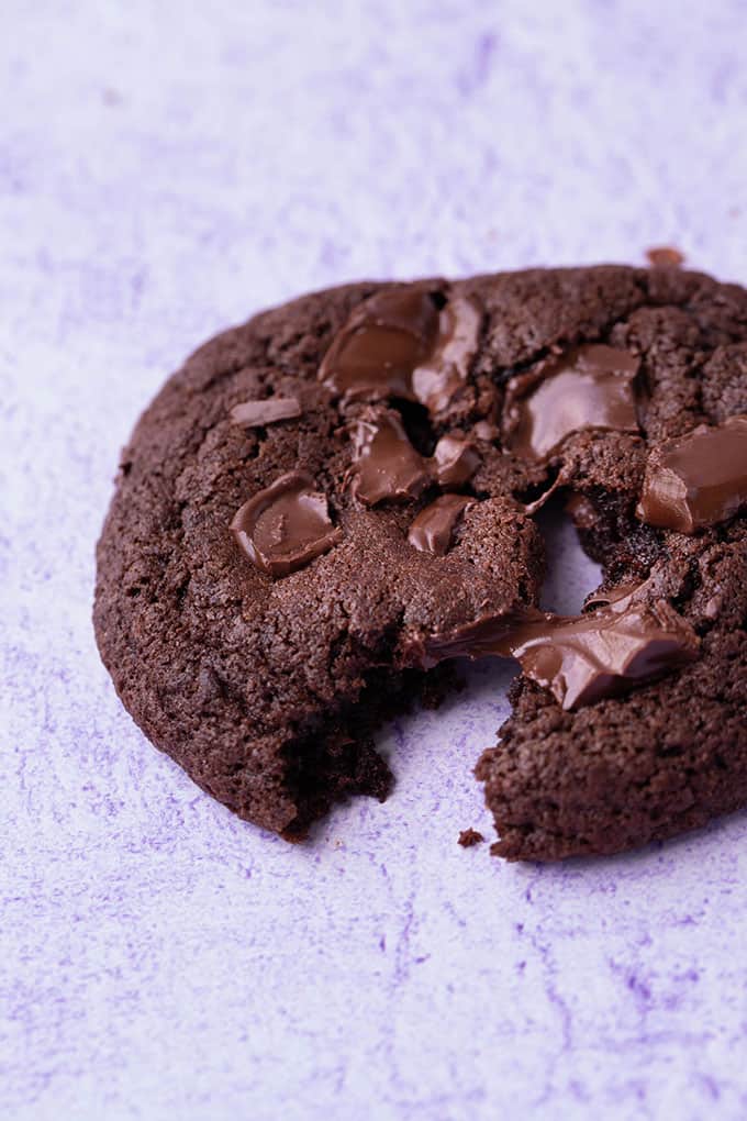 A close up of a Chocolate Fudge Cookie broken in half
