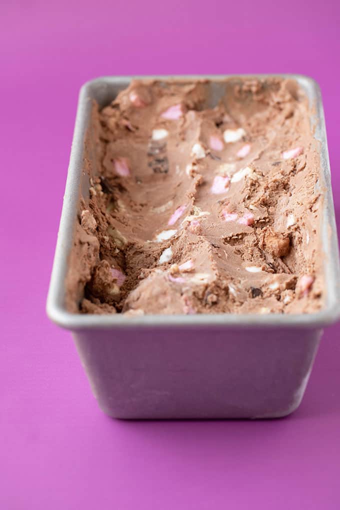 A cake tin filled with homemade rocky road ice cream