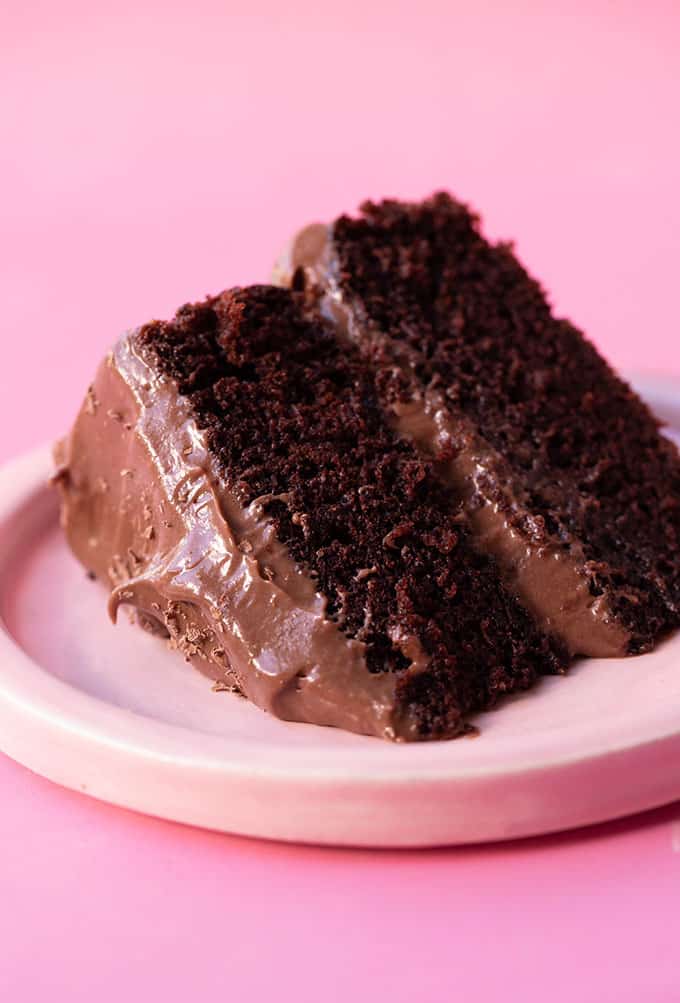 A big slice of homemade Chocolate Olive Oil Cake on a pink plate
