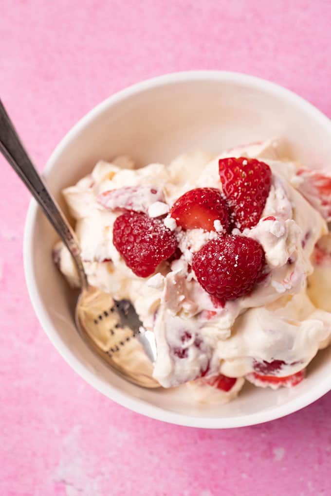 Top view of a bowl of Eton Mess topped with fresh raspberries