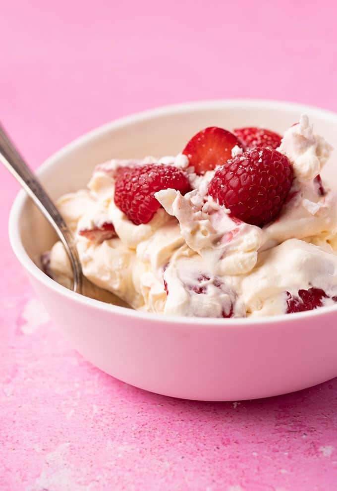 A bowl of Eton Mess on a pink background