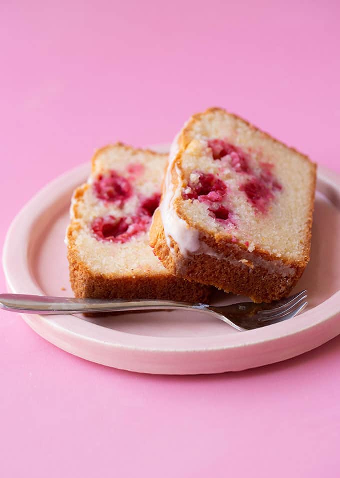 Two slices of Lemon Raspberry Loaf on a pink plate